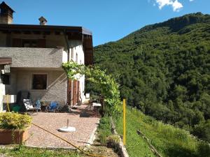 a house on the side of a mountain at B&b CASCINA CORNELLA in Cremeno
