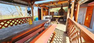 a porch with a wooden bench on a house at Oscar Apartman Rezi in Rezi