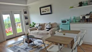 a living room with a couch and a table at Elevated Horizon Retreat in Chilliwack