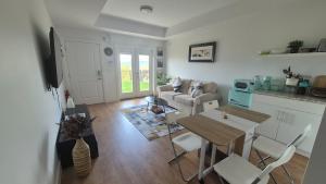 a living room with a couch and a table and chairs at Elevated Horizon Retreat in Chilliwack