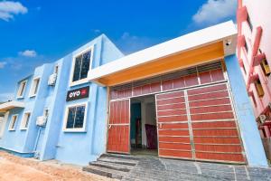 a blue building with an open garage door at Hotel O Blue Valley in Khandagiri +21 photos