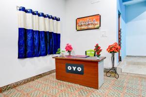 a reception desk in a room with flowers on it at Hotel O Blue Valley in Khandagiri