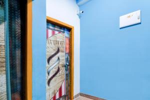 a door with a painting on the side of a building at Hotel O Blue Valley in Khandagiri