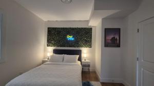a bedroom with a bed and a painting on the wall at Elevated Horizon Retreat in Chilliwack