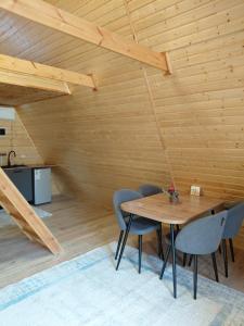 a wooden room with a wooden table and chairs at Kolsai Star House in Saty