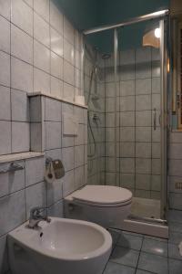 a bathroom with a toilet and a sink and a shower at Stella Marina in Giardini Naxos