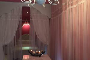 a room with a chandelier and a table with candles at CS Premier Hotel in Anyang +82 photos