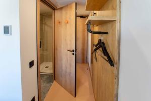 a stairway leading to a bathroom with a sliding door at easyHotel Alicante Centro in Alicante