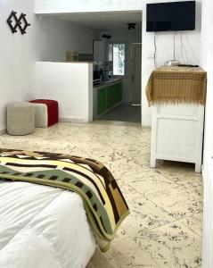 a living room with a bed and a kitchen at Little apartment in Hammamet