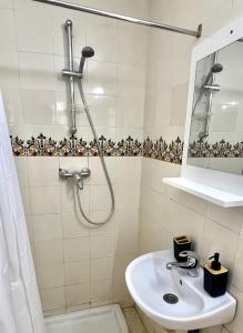a bathroom with a shower and a sink at Little apartment in Hammamet