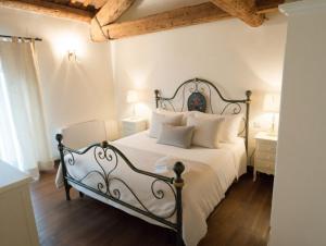 a bedroom with a large bed with white sheets and pillows at Agriturismo Villa Anconetta in Loreo +26 photos