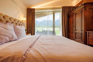 a bedroom with a large bed with a large window at Villa Sofayla w Jacuzzi near the Pirin Golf Resort in Bansko +41 photos