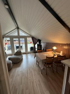 a large living room with a table and chairs at Glamping Cabin Wilderness bathing and relaxation in Silkeborg