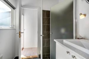 a bathroom with a shower and a sink and a mirror at Glamping Cabin Wilderness bathing and relaxation in Silkeborg +11 photos