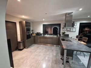 a large kitchen with a large island in a room at Au bon moment in Rang-du-Fliers