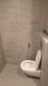 a bathroom with a toilet in a wall at Romaer's Room in Greater Noida +2 photos
