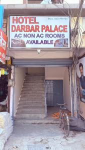a sign for a hotellor palace with a staircase and a sign for a hotel at HoTEL DARBAR PALACE in Dewās