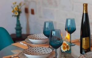 a table with three wine glasses and a bottle of wine at Villa Marcella by the Sea in Kamisianá +8 photos