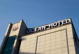 a building with a sign on top of it at Ocean Hotel Pohang in Pohang
