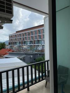 a balcony with a view of a hotel at The Smoke Shop in Ban Suan