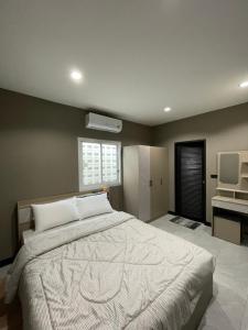 a bedroom with a large bed and a television at The Smoke Shop in Ban Suan +10 photos