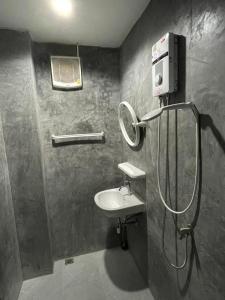 a bathroom with a sink and a shower at The Smoke Shop in Ban Suan