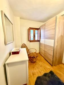 a kitchen with a refrigerator and a wooden floor at Casita Loredo in Mieres