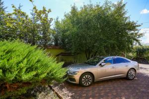 a car parked in a driveway next to a house at Casa RUXI in Jiblea Veche +3 photos