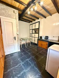 a kitchen with a table and a dining room at Casita Loredo in Mieres +14 photos