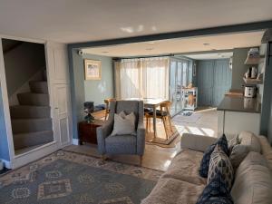 a living room with a couch and a table at York Cottage in Southwold