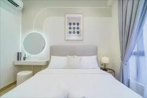 a bedroom with a white bed and a window at Piccadilly Service Residence Greentown Ipoh in Ipoh