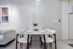 a dining room with a white table and white chairs at Piccadilly Service Residence Greentown Ipoh in Ipoh +93 photos