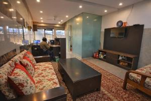 a living room with a couch and a coffee table at Mauryan Elite Hotel Vasant Kunj in New Delhi