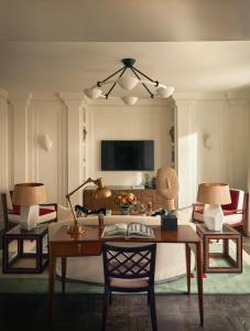 a living room with a table and two chairs at Rocco Forte The Carlton in Milan
