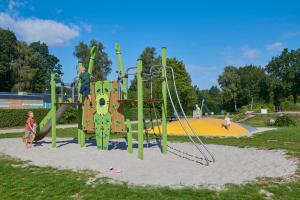 a child playing on a playground in a park at Siblu De Lente van Drenthe in Gasselte