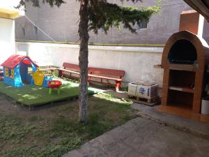 a park with a bench and a play area at Casa Paloma in Costinesti