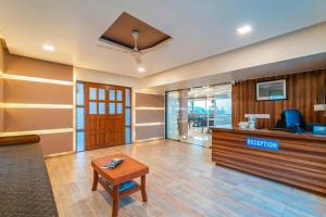a lobby with a reception desk and a table at Kaizen Stays And Resto in Panchgani