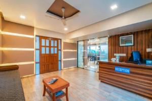 a lobby with a reception desk and a table at Kaizen Stays And Resto in Panchgani