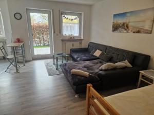 a living room with a couch and a table at Ferienwohnung Unterneukirchen mit Garten-Terrasse in Unterneukirchen