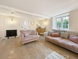 a living room with a couch and a chair at Vine Cottage in Thornham