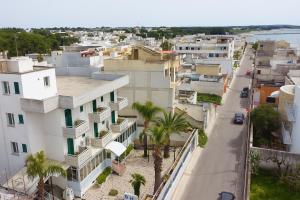 an aerial view of a city with buildings and palm trees at Hotiday Porto Cesareo in Porto Cesareo