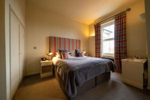 a bedroom with a bed and a window at The Pier Hotel in Harwich