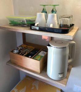 a coffee maker sitting on a shelf with a box at Stanza con terrazzo vista lago LAKEHOLIDAY IT in Castel di Tora