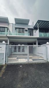 a house with a white fence in front of it at Alpha 2 in Johor Bahru