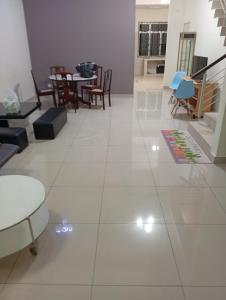 a large white tiled floor with chairs and tables at Alpha 2 in Johor Bahru