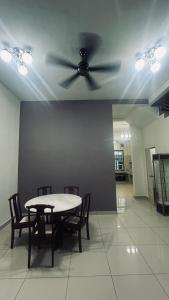 a ceiling fan in a room with a table and chairs at Alpha 2 in Johor Bahru +17 photos