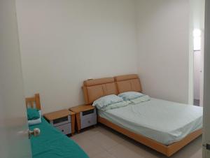 a small bedroom with a bed and a night stand at Alpha 2 in Johor Bahru