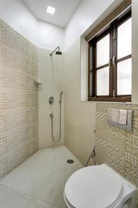 a bathroom with a toilet and a shower at Avanti Tenantry-Luxurious Service Apartments in New Delhi +45 photos