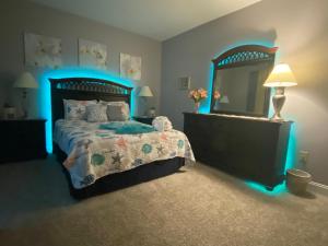 a bedroom with a bed and a large mirror at First Class Treatment Luxurious end unit Patio Pool Restaurant Bar on premises Steps away from Everything else! Spacious Condo Stocked with all You Need! in Myrtle Beach
