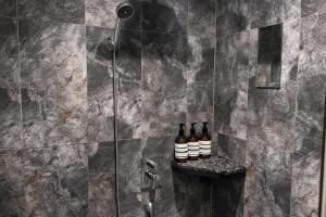 three bottles of wine sitting on a shelf in a shower at Zenith Tourist Hotel in Bucheon